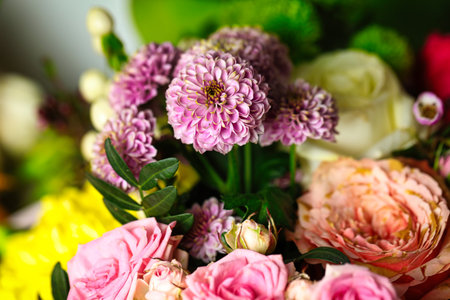 A vibrant bunch of flowers in a vase, perfect for adding a pop of color to any space.の写真素材