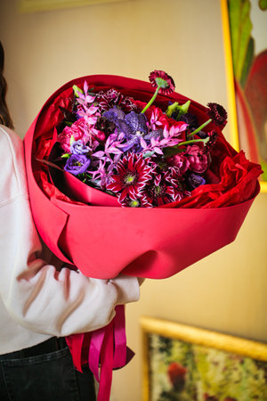 A woman holding a beautiful bouquet of flowers with copy space.の写真素材