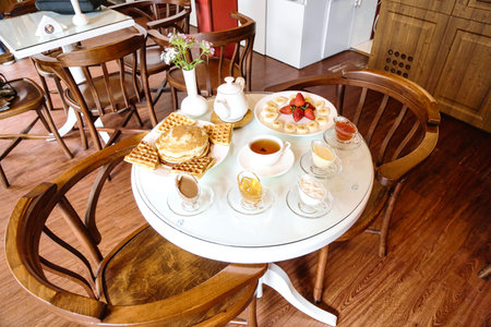 A white table showing various plates of delicious food.