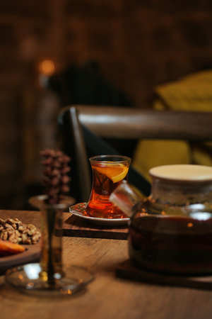 A wooden table features a plate of delicious food and a cup of tea.