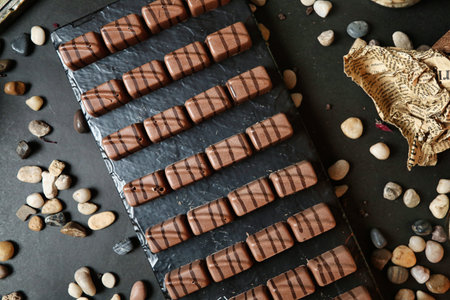 A table covered with a variety of chocolates and nuts.