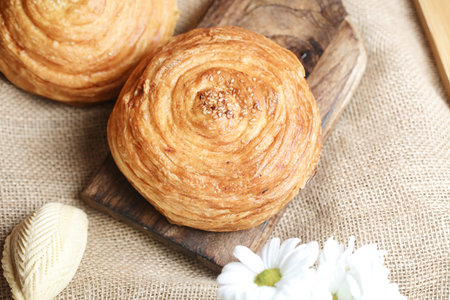 Two delicious pastries are placed neatly on a sturdy wooden cutting board.