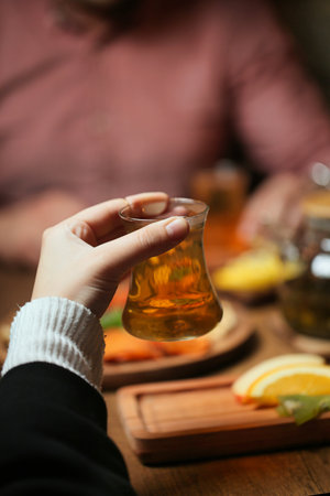 A persons hand holds a beaker filled with liquid.の写真素材