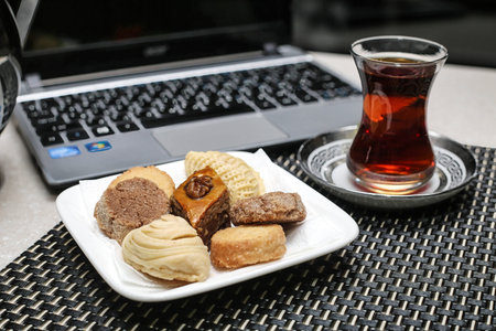 A plate filled with a variety of delicious pastries, such as croissants and Danishes, placed next to...