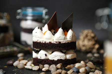 A piece of mouthwatering cake rests on top of a sturdy wooden table.