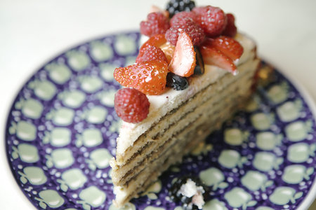 A delicious slice of cake resting on a blue and white plate.