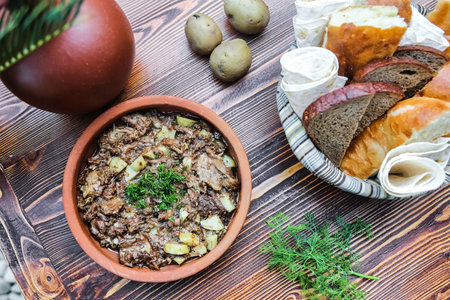 A bowl filled with food is placed on top of a wooden table.