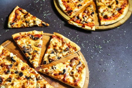 A close-up photo of a sliced pizza resting on a sturdy wooden cutting board.