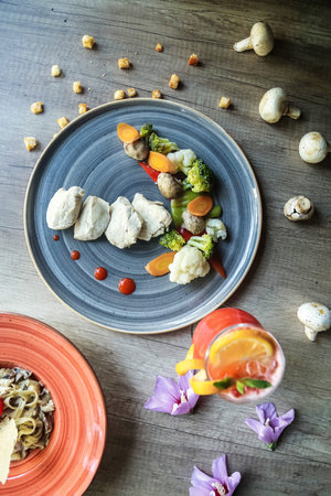 A delectable assortment of food items beautifully arranged on a sturdy wooden table.