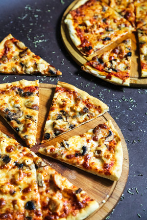 A photo of a slice of pizza neatly arranged on a wooden cutting board.