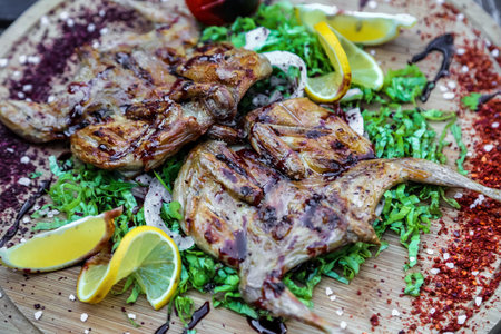A detailed view of a plate filled with a variety of meat dishes, showcasing the textures and...