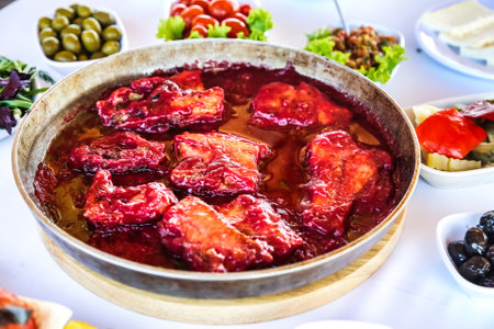 A large colorful bowl of food placed on a wooden table.の写真素材
