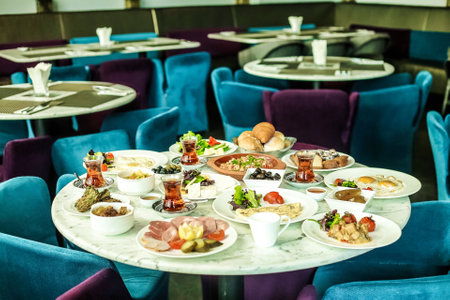 A table is covered with an array of plates filled with a wide variety of delicious food.の写真素材