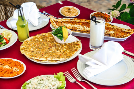 A table covered in a variety of dishes and plates, showcasing a delicious and vibrant assortment of food.の写真素材