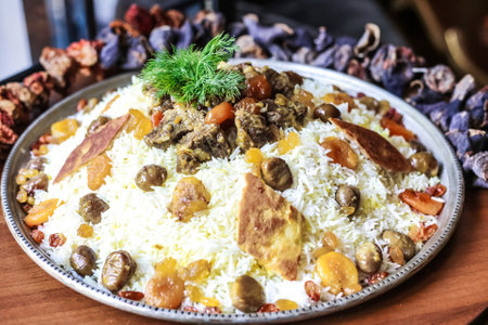 A sumptuous plate of food comprising various dishes placed on a rustic wooden table.の写真素材