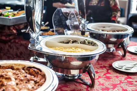 A detailed view of a buffet table filled with an abundance of appetizing food options.の写真素材