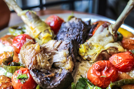 A detailed view of a plate filled with a variety of meats and vegetables, showcasing a flavorful and balanced meal.の写真素材