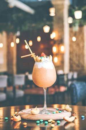 A refreshing drink is placed on a sturdy wooden table, creating a pleasing contrast of textures.の写真素材