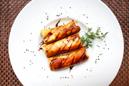 A white plate holds a thoughtfully arranged meal on top of a sturdy table.の写真素材