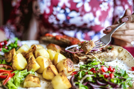 A close-up photograph capturing a plate of mouth-watering food with a fork resting on top.