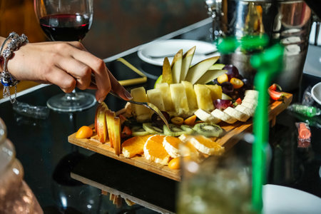 A detailed view of a person slicing fruit on a cutting board.の写真素材