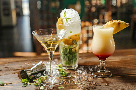 A wooden table displaying three distinct beverages, exemplifying variety and choice.