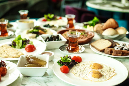 A variety of delectable dishes and cuisines presented on multiple plates arranged neatly on a table.の写真素材