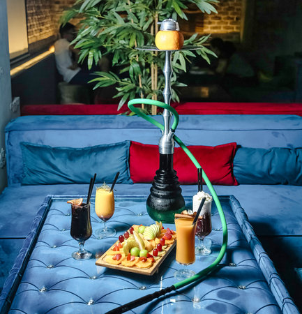 A photo of a blue couch with a tray of food placed on it.の写真素材