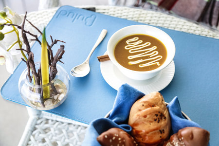 A table showcases a plate of food and a cup of coffee.