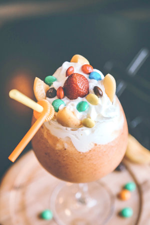 A mouthwatering dessert featuring a sugary straw and colorful candy adorning the top.の写真素材