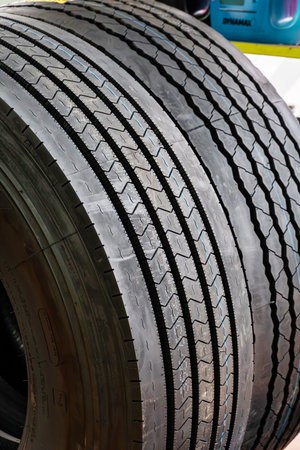 A close-up view of a truck tires tread pattern, showcasing the intricate detail of the grooves and...