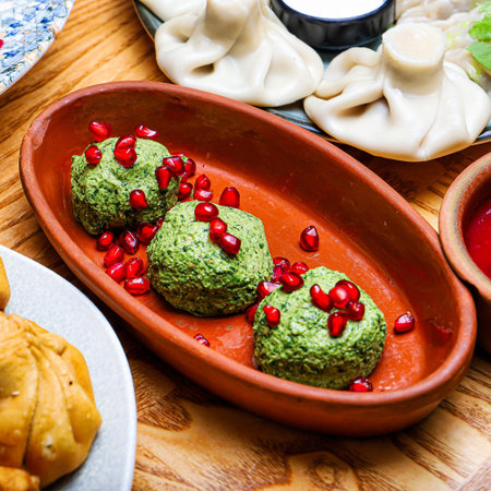 A close-up of three servings of Georgian pkhali topped with pomegranate seeds. The dish is served in...