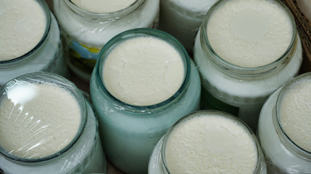 Close-up shot of glass jars filled with creamy white yogurt.