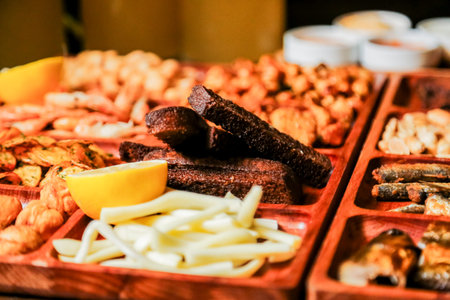 A vibrant platter showcases a variety of grilled meats, cheeses, and garnishes. The wooden trays are...