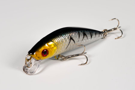 This detailed fishing lure features a sleek body with a shimmering finish, designed to imitate small fish. Ideal for freshwater fishing during sunny days.の写真素材