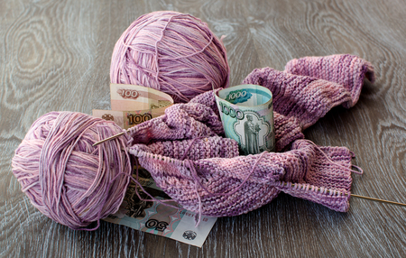 Skeins of yarn purple color and paper moneyの写真素材