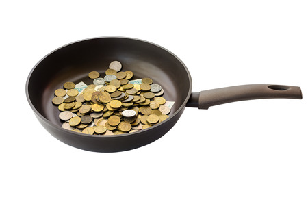 Non-stick frying pan with banknotes and coins isolated on white backgroundの写真素材