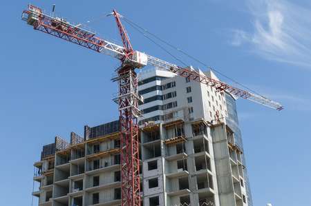 A new building and red crane on the sky backgroundの写真素材