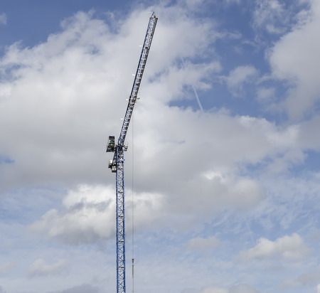 Single building crane against the blue cloudy skyの写真素材