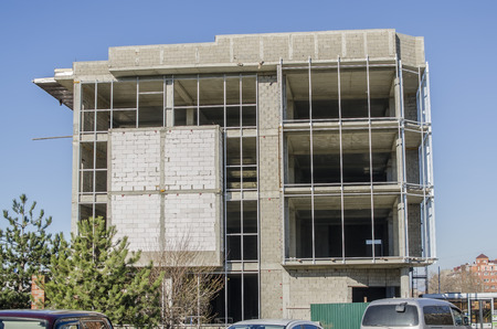 Grey brick unfinished house on 4 floors.の写真素材