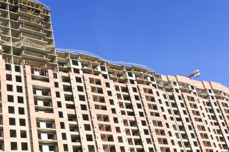 Foreground of a brown building against a blue skyの写真素材