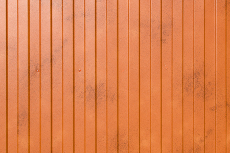 Orange metal surface with vertical even stripesの写真素材