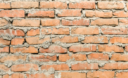 Brown brick wall with cement mortar streaksの写真素材