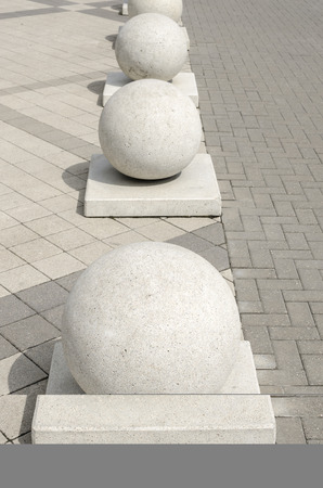 Stone balls on plates installed in a rowの写真素材