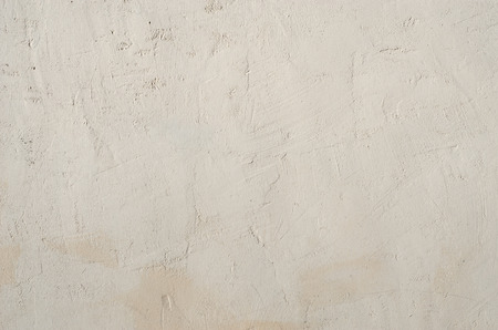 Background of gray rough plaster surfaces with scratches and scuffsの写真素材