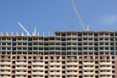 Front view of a monolithic concrete building under construction.の写真素材