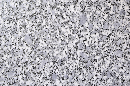 Granular background of gray color with black impregnationsの写真素材