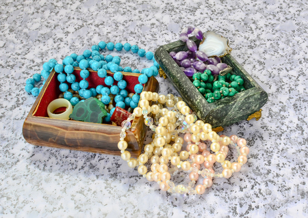 Caskets from onyx and serpentine with a beads from turquoise, malachite, pearls, amethyst close up.の写真素材