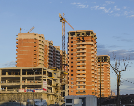 Three brown buildings and bunk parking under constructionのeditorial素材