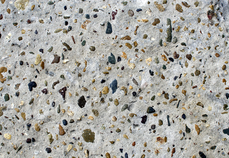 Texture of gray concrete with impregnations of different colors.の写真素材